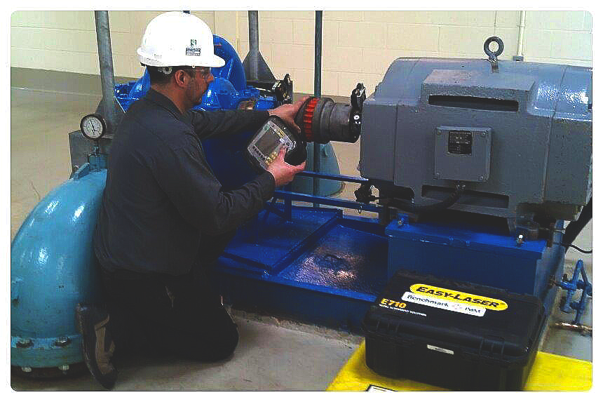 Man laser aligning a pump